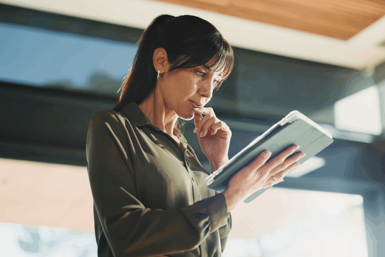 An attorney reading a disaster readiness plan on an ipad in her office