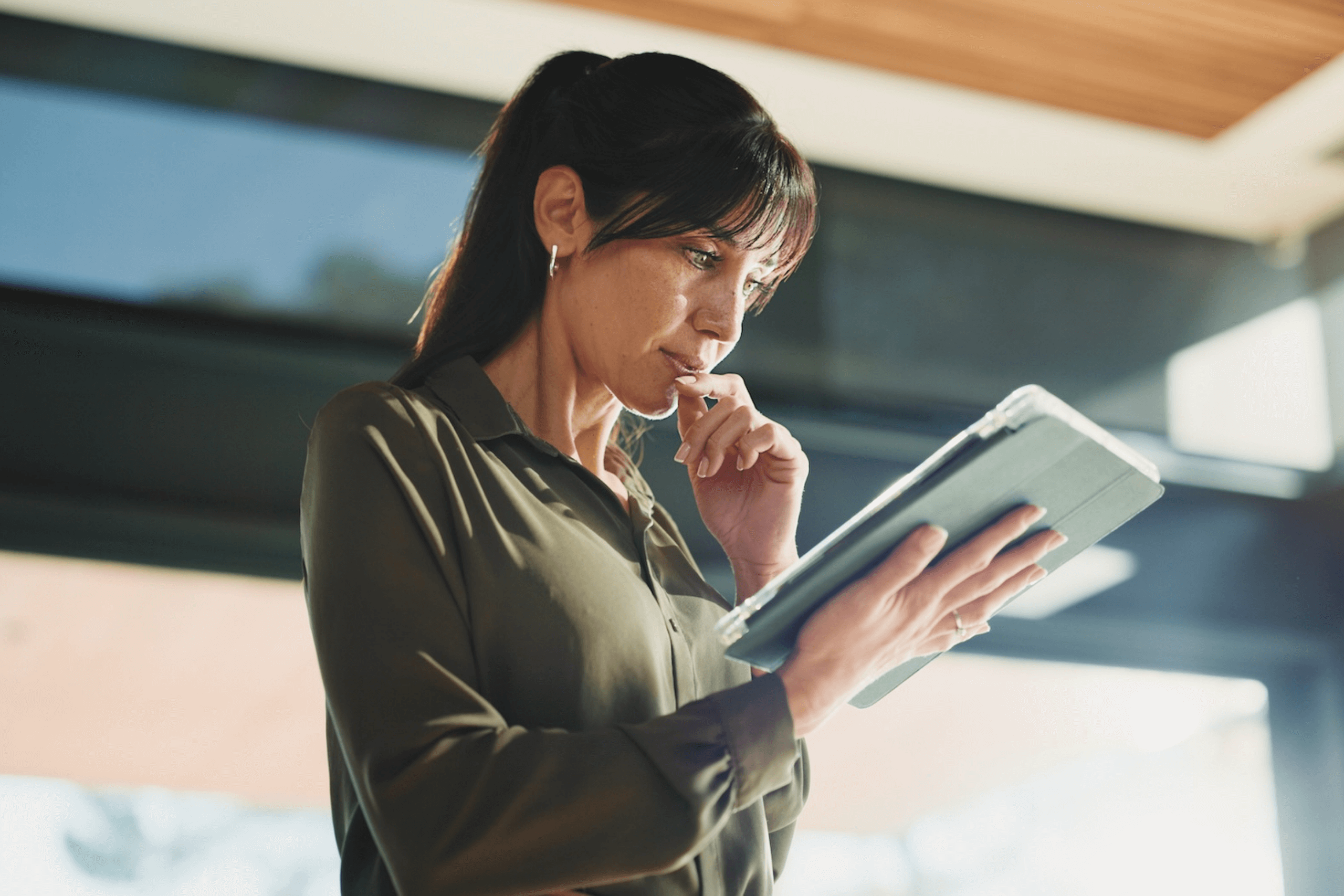 An attorney reading a disaster readiness plan on an ipad in her office