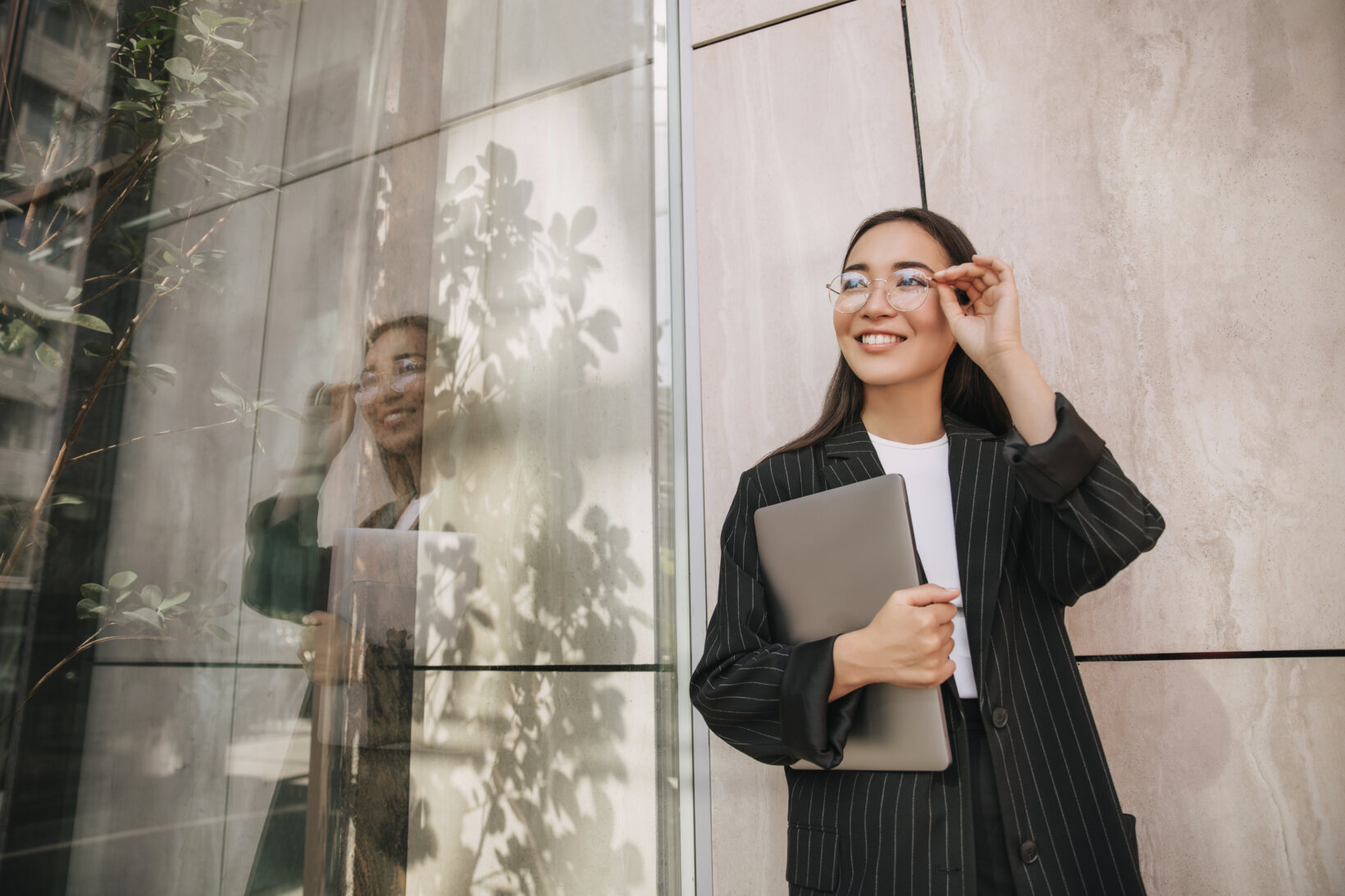 Happy, successful law student standing outside of a building