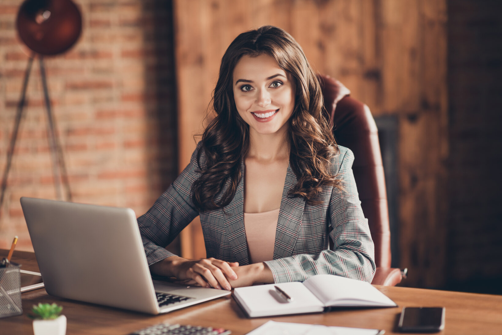 Cheerful solo practitioner sitting at her desk