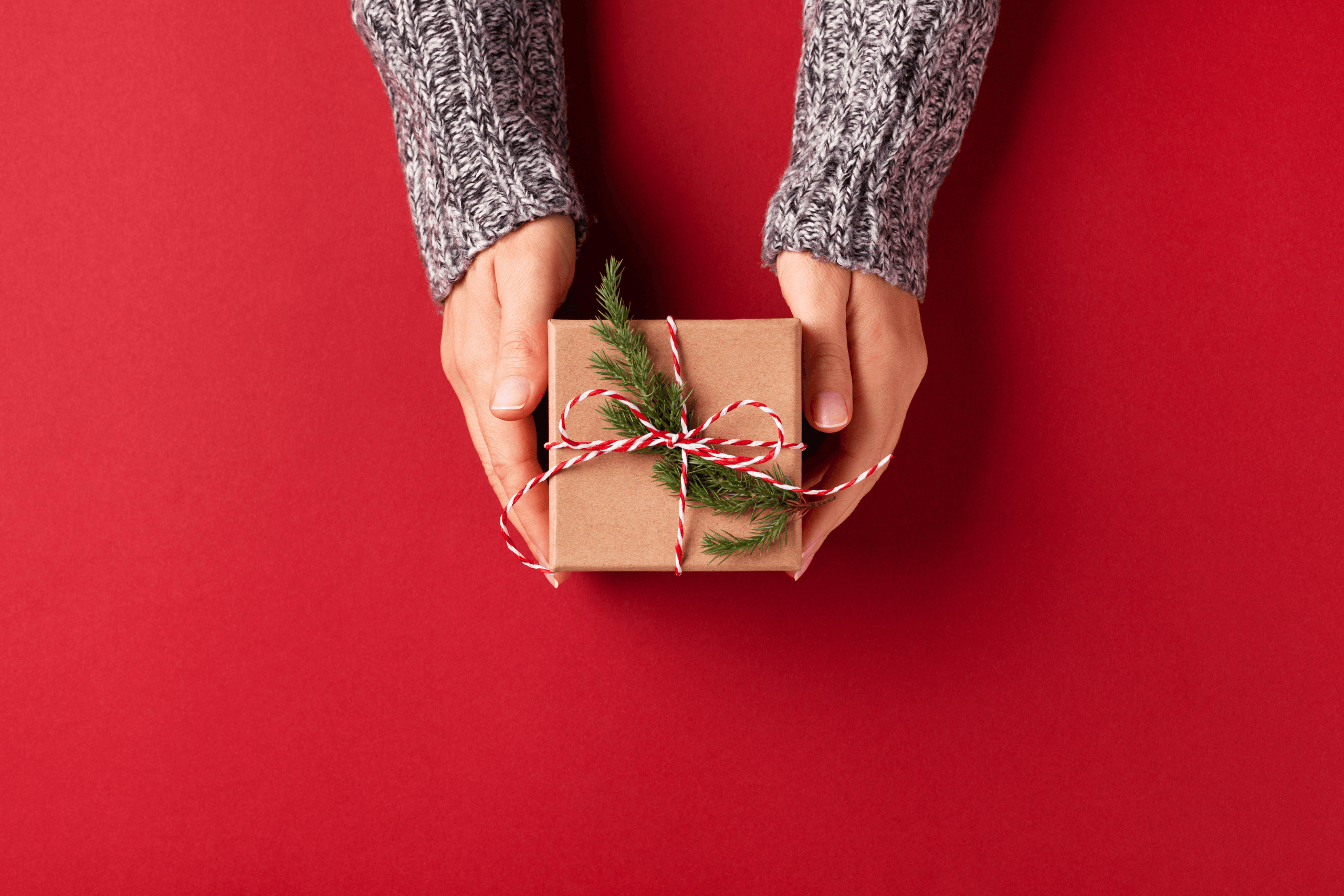 A person handing a festive gift to someone