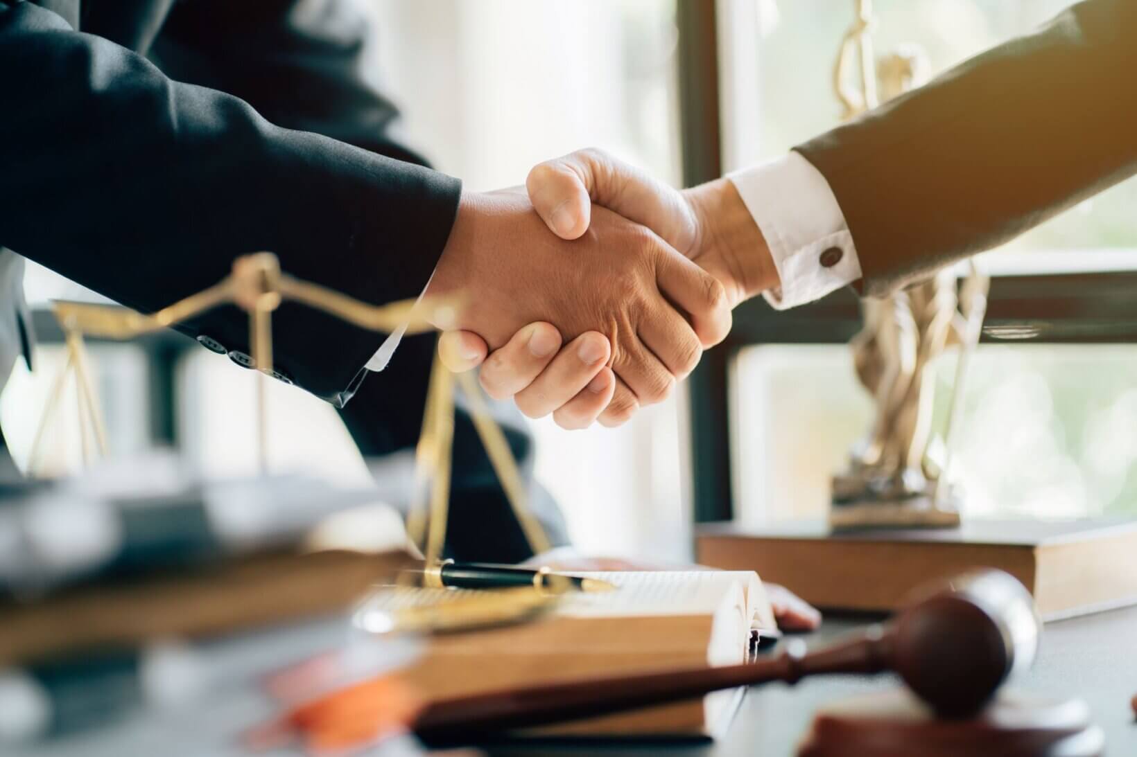 A lawyer shaking hands with a client after opening a client trust account.