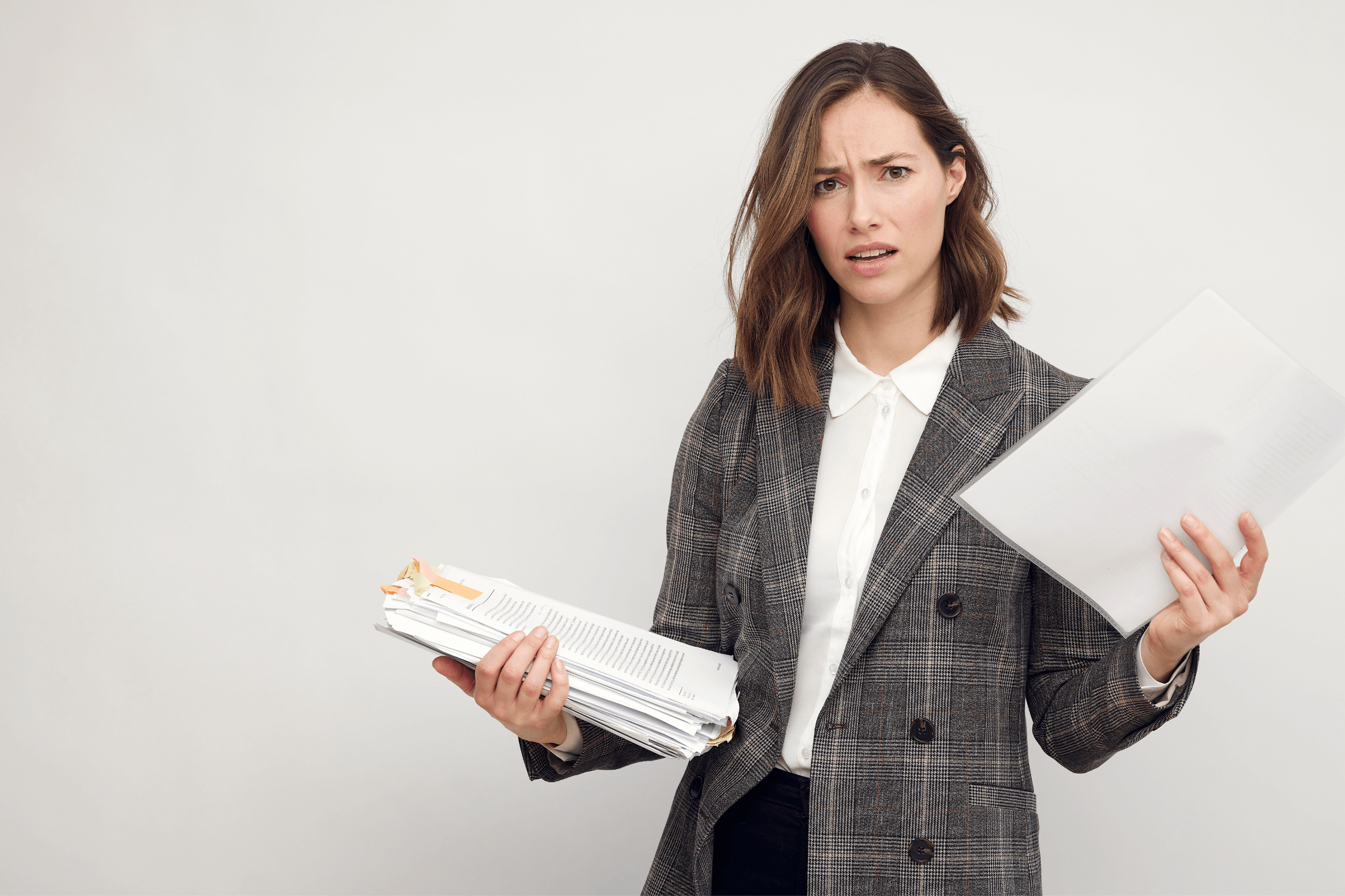 Confused probate attorney holding a stack of wills